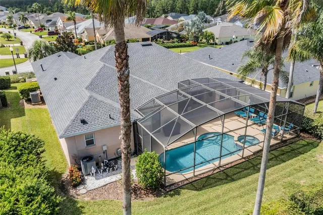 an aerial view of a house with a yard and sitting area