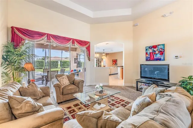 a living room with furniture a rug and a flat screen tv