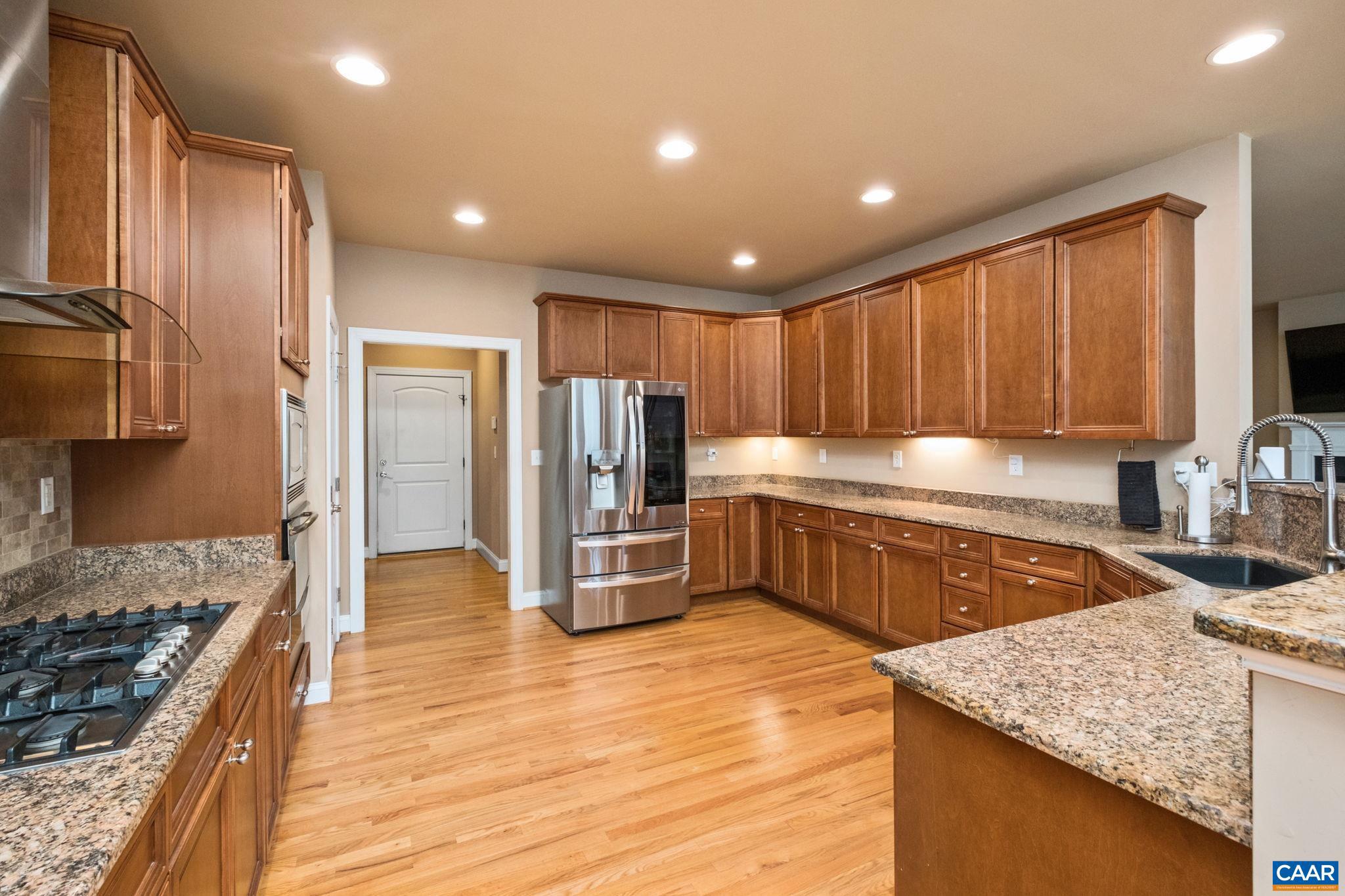 612 London Court Ruckersville, VA 22968 - Photo 16 of 55 a kitchen with stainless steel appliances granite countertop a stove a sink and a refrigerator