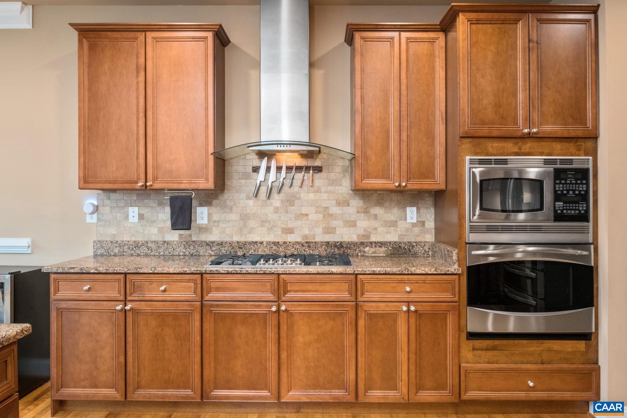 612 London Court Ruckersville, VA 22968 - Photo 19 of 55 a kitchen with granite countertop wooden cabinets and a stove
