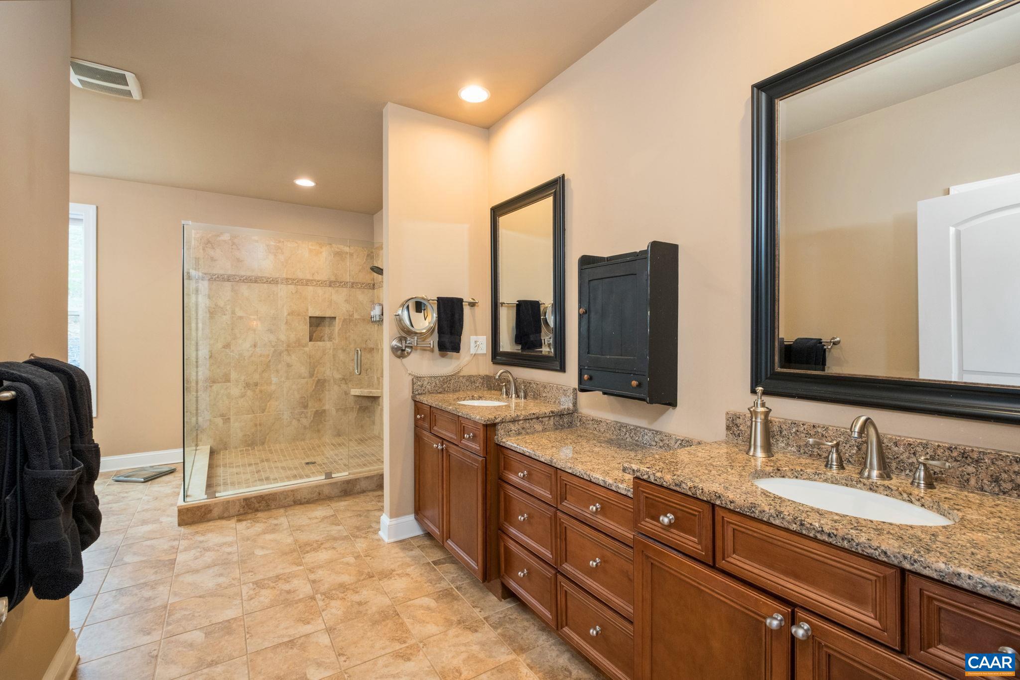 612 London Court Ruckersville, VA 22968 - Photo 23 of 55 a bathroom with a granite countertop sink mirror and shower