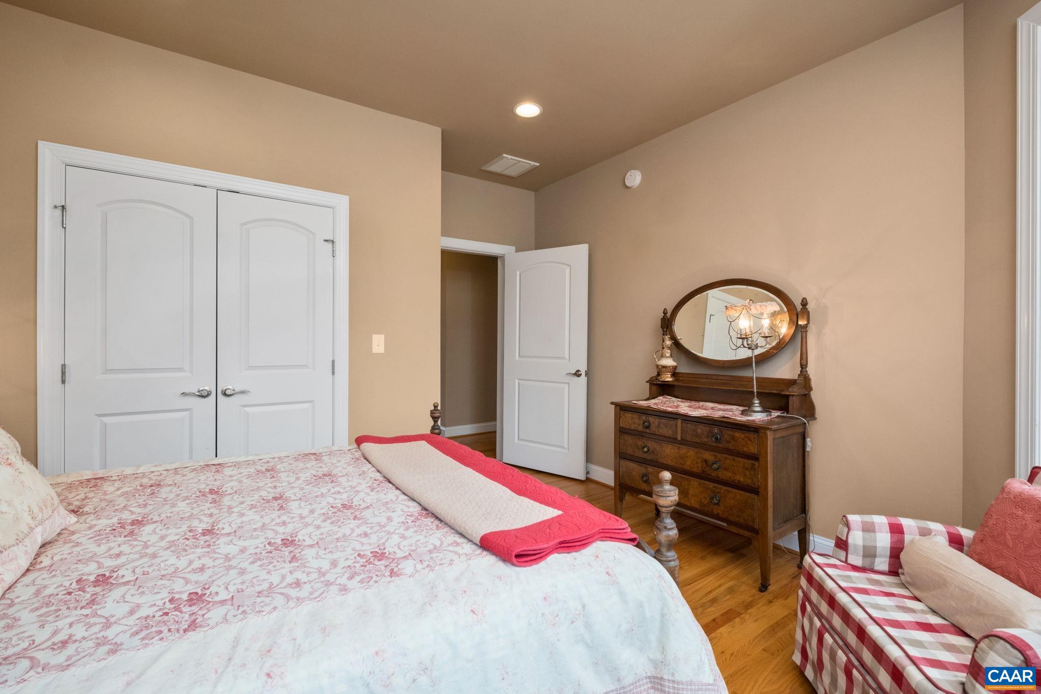 612 London Court Ruckersville, VA 22968 - Photo 29 of 55 a bedroom with a bed and dresser with mirror