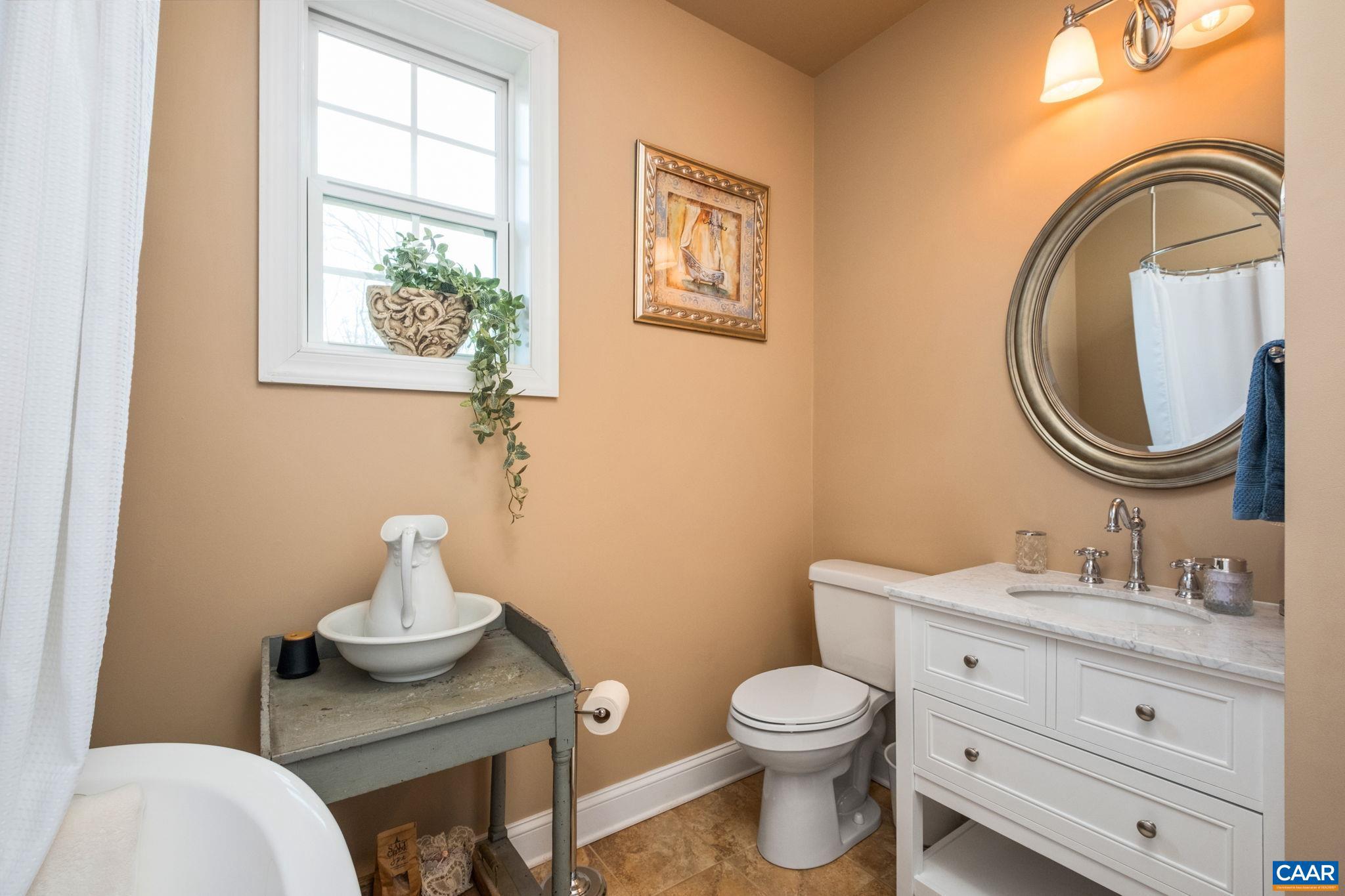 612 London Court Ruckersville, VA 22968 - Photo 31 of 55 a bathroom with a toilet a sink and a mirror