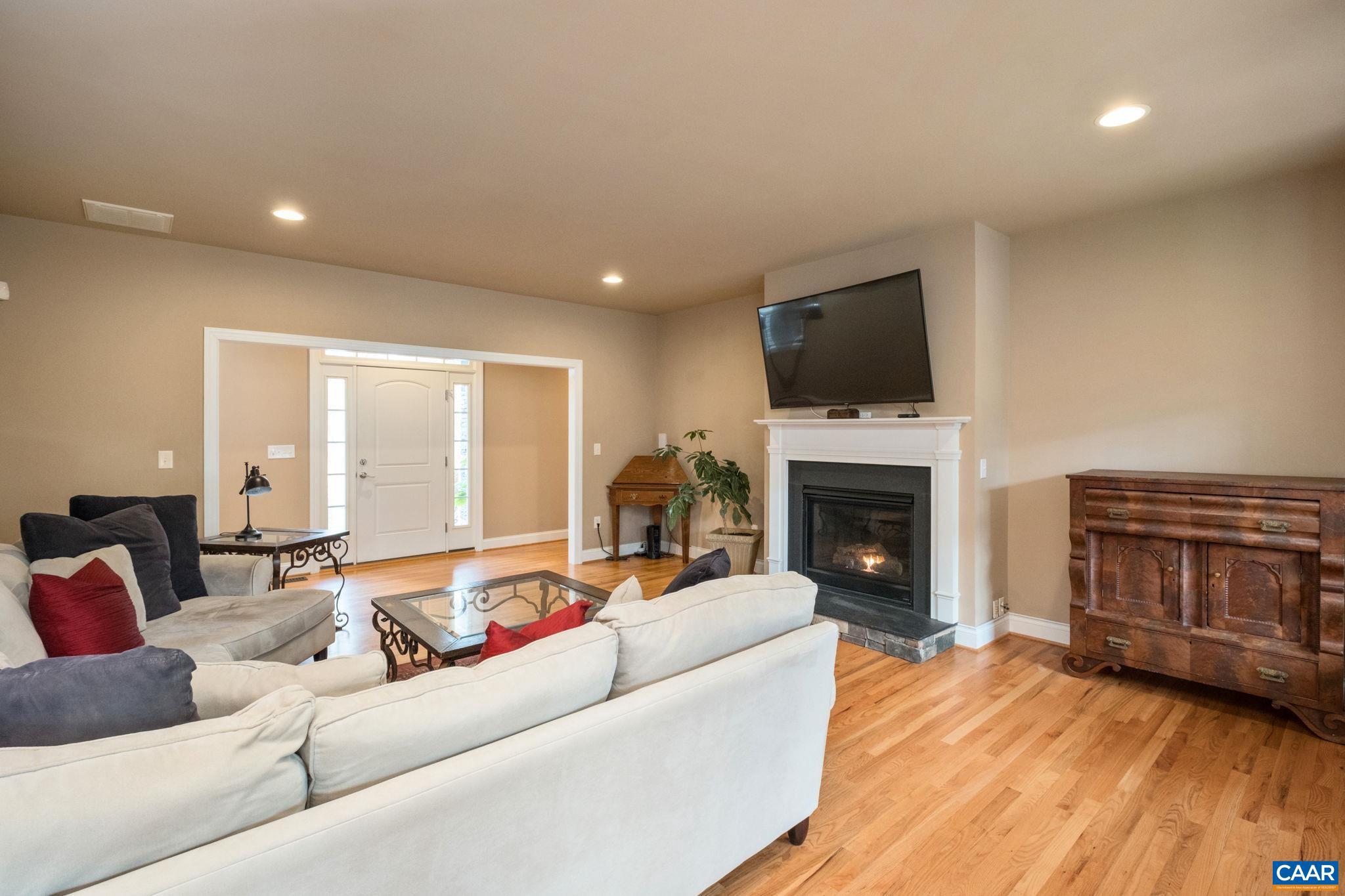 612 London Court Ruckersville, VA 22968 - Photo 9 of 55 a living room with furniture a fireplace and a flat screen tv