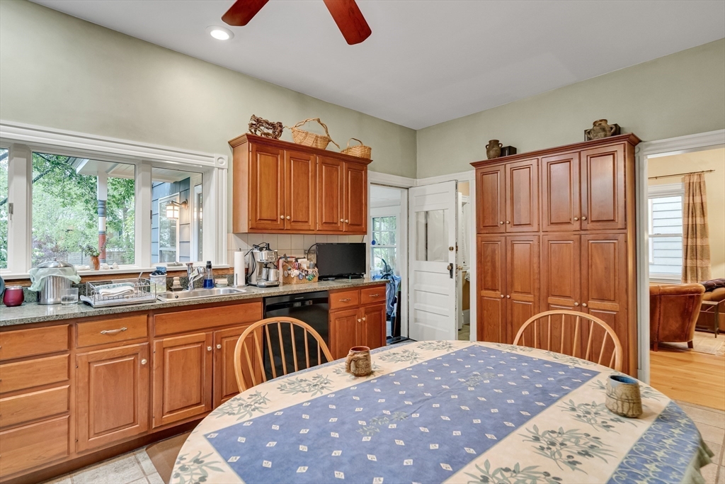 95 Cushing Street Cambridge, MA 02138 - Photo 11 of 21 a kitchen with stainless steel appliances granite countertop a stove a sink dishwasher a microwave oven with cabinets and wooden floor