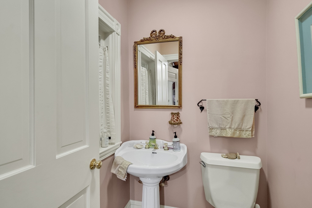 95 Cushing Street Cambridge, MA 02138 - Photo 13 of 21 a bathroom with a sink and mirror with toilet
