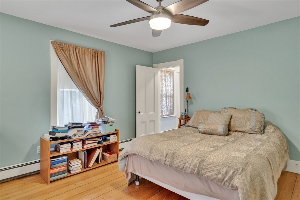 95 Cushing Street Cambridge, MA 02138 - Photo 14 of 21 a bedroom with a bed and a chandelier