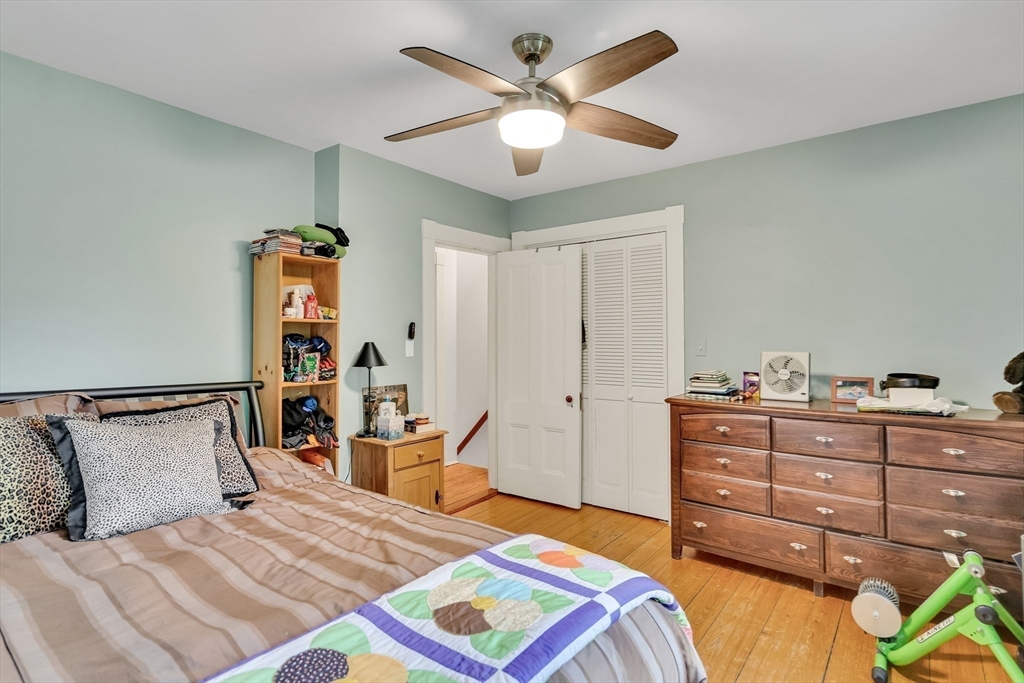 95 Cushing Street Cambridge, MA 02138 - Photo 15 of 21 a bedroom with a bed and a chandelier