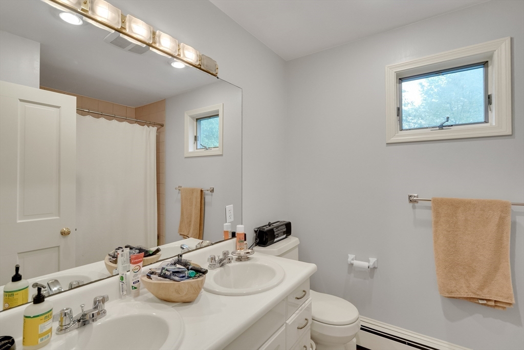 95 Cushing Street Cambridge, MA 02138 - Photo 18 of 21 a white toilet sitting next to a bathroom sink