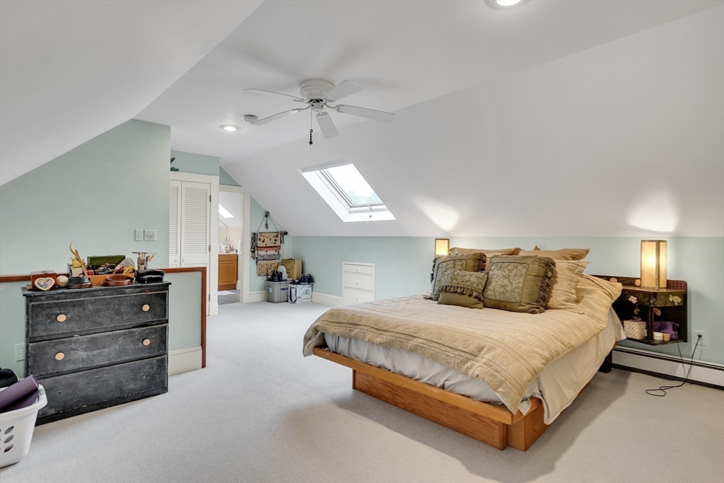95 Cushing Street Cambridge, MA 02138 - Photo 20 of 21 a spacious bedroom with a bed and a chandelier
