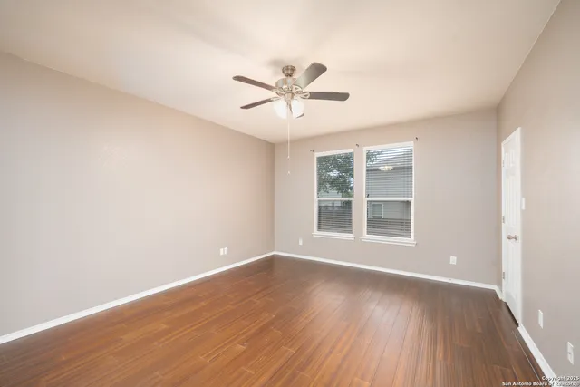 a view of a livingroom with a ceiling fan and window