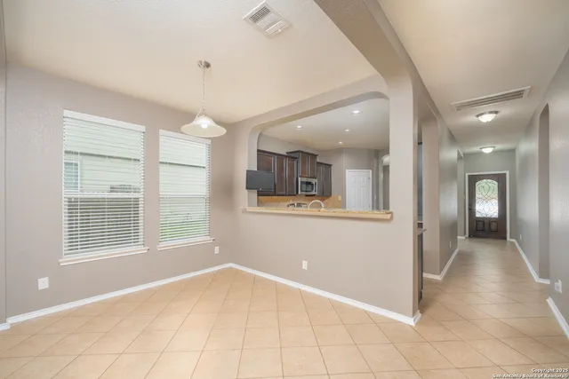 a view of a livingroom with wooden floor and kitchen space with a sink