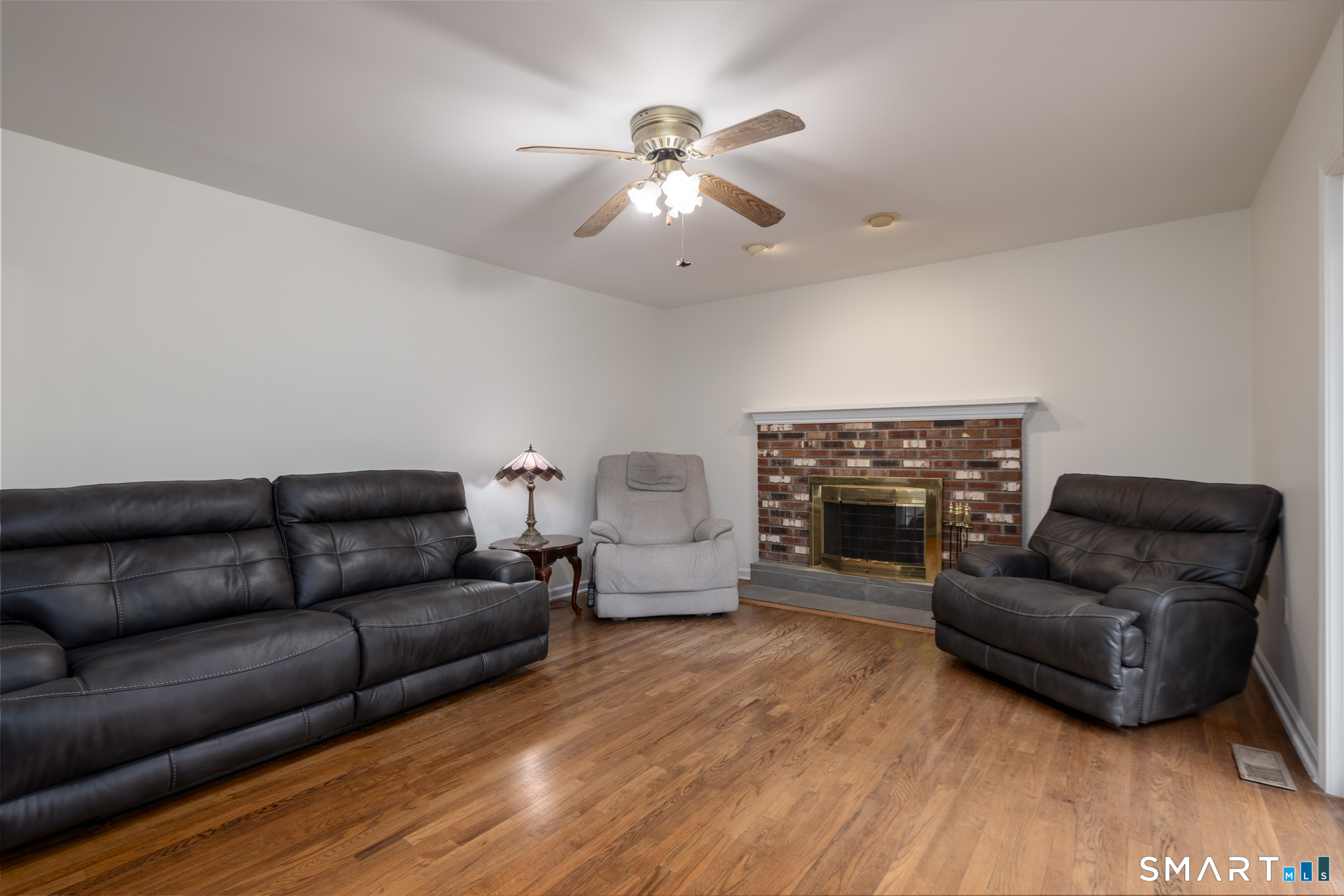 90 Fenn Road Middlebury, CT 06762 - Photo 6 of 34 Family room with wood floors and fireplace.