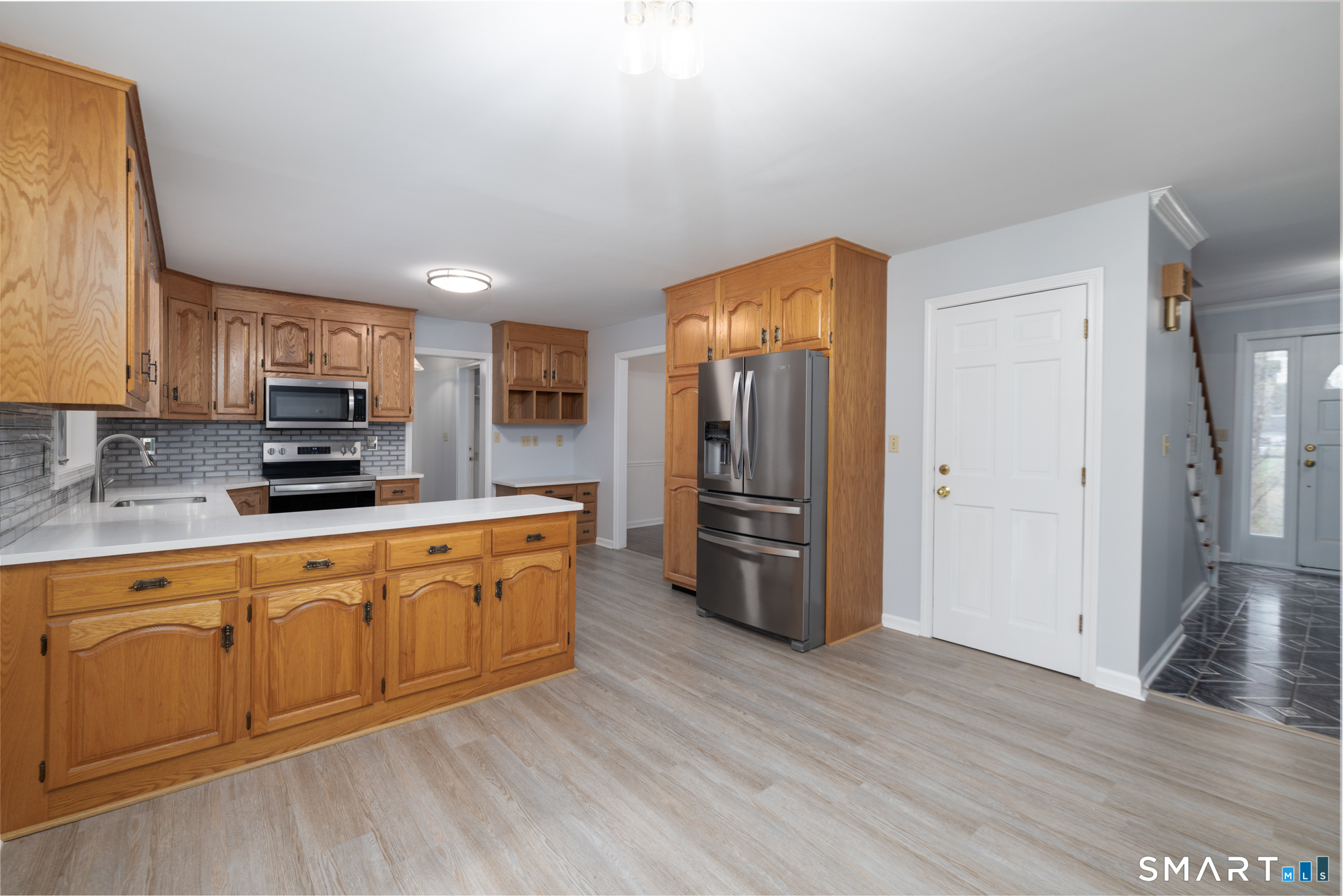 90 Fenn Road Middlebury, CT 06762 - Photo 9 of 34 Eat in kitchen with quartz counter tops, newly painted walls and composite floors.
