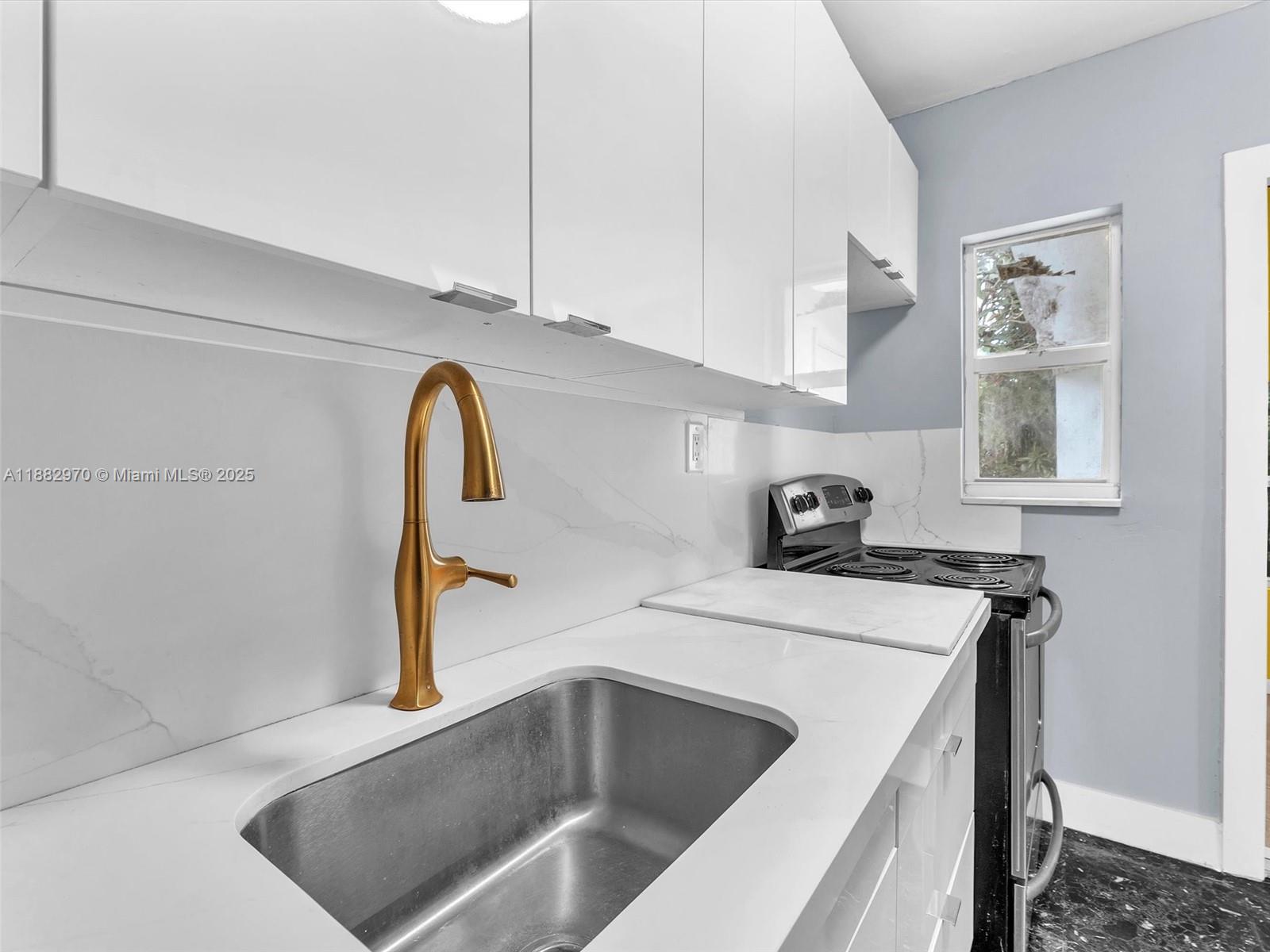 3680 Northwest 16th Street Miami, FL 33125 - Photo 14 of 45 a view of a sink a washer and dryer