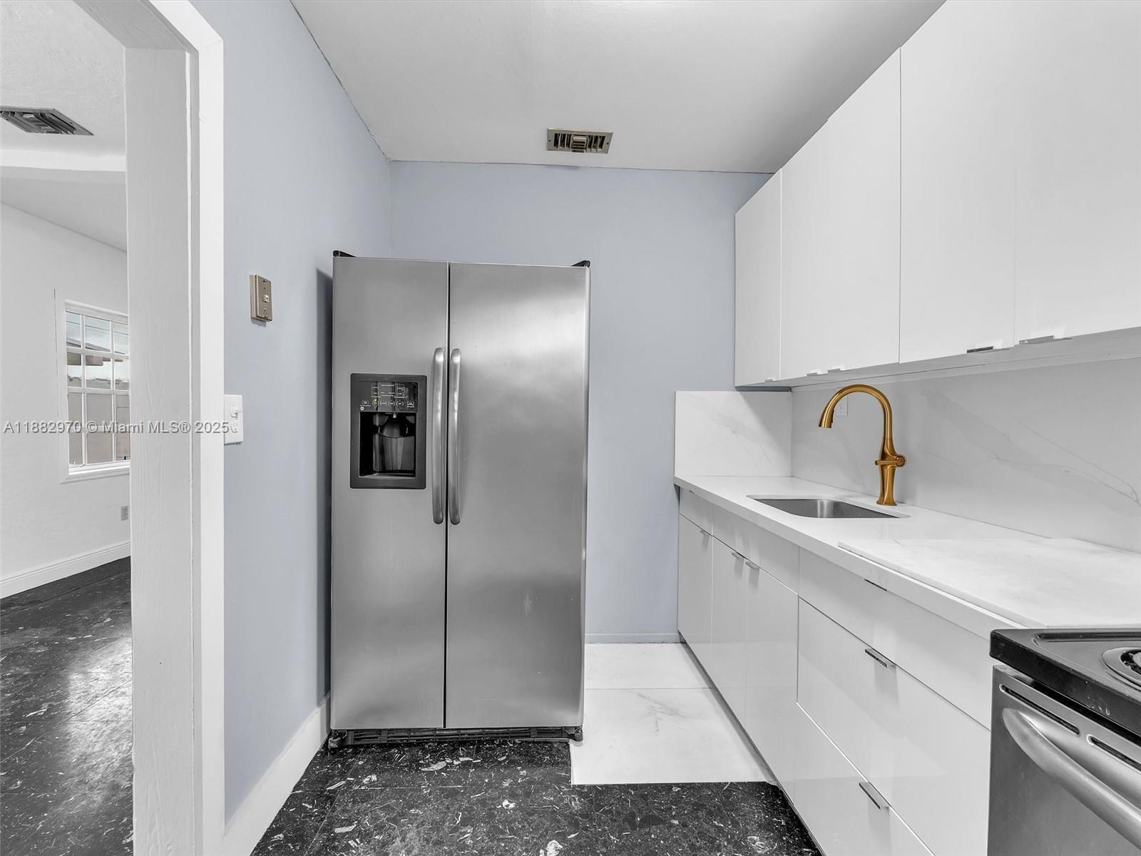 3680 Northwest 16th Street Miami, FL 33125 - Photo 15 of 45 a kitchen with a sink and refrigerator