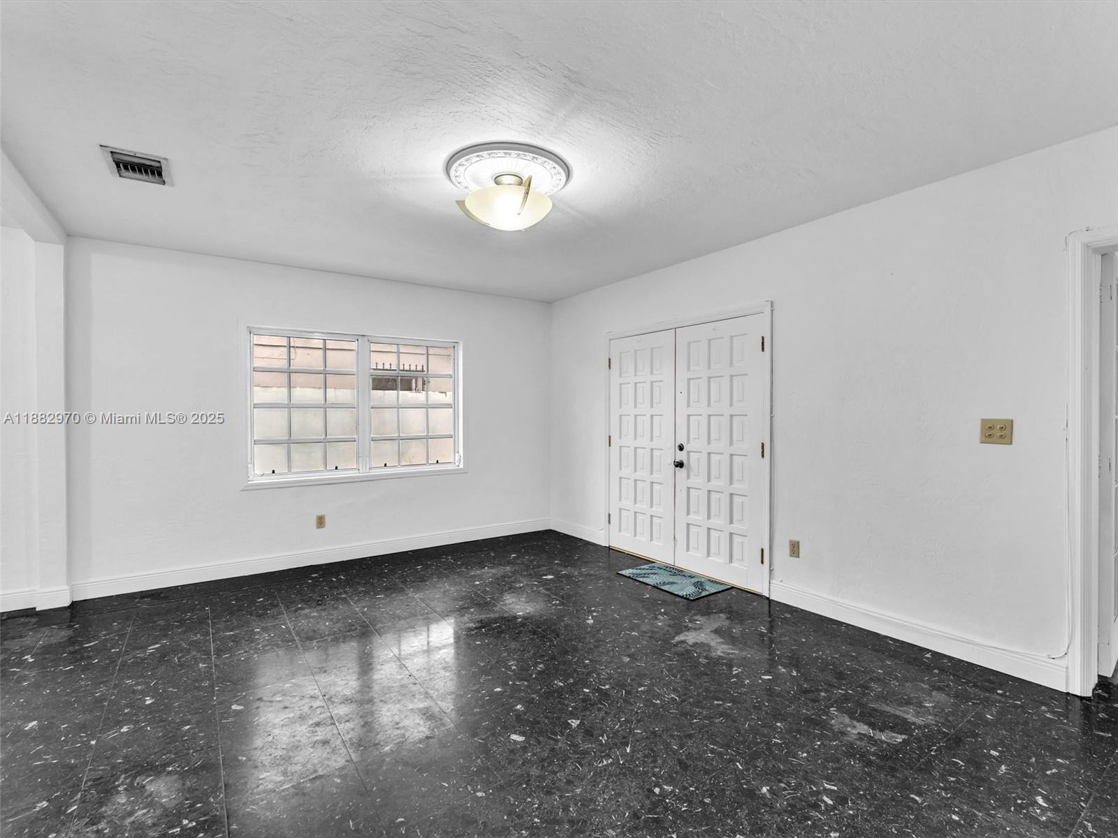 3680 Northwest 16th Street Miami, FL 33125 - Photo 16 of 45 an empty room with windows