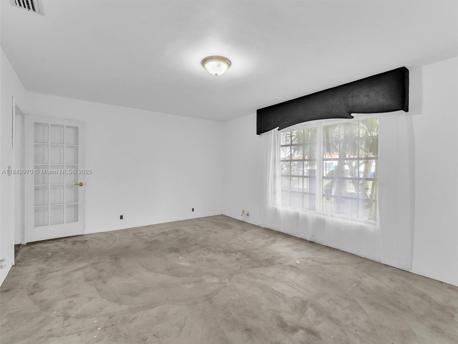 3680 Northwest 16th Street Miami, FL 33125 - Photo 18 of 45 a view of an empty room with a window