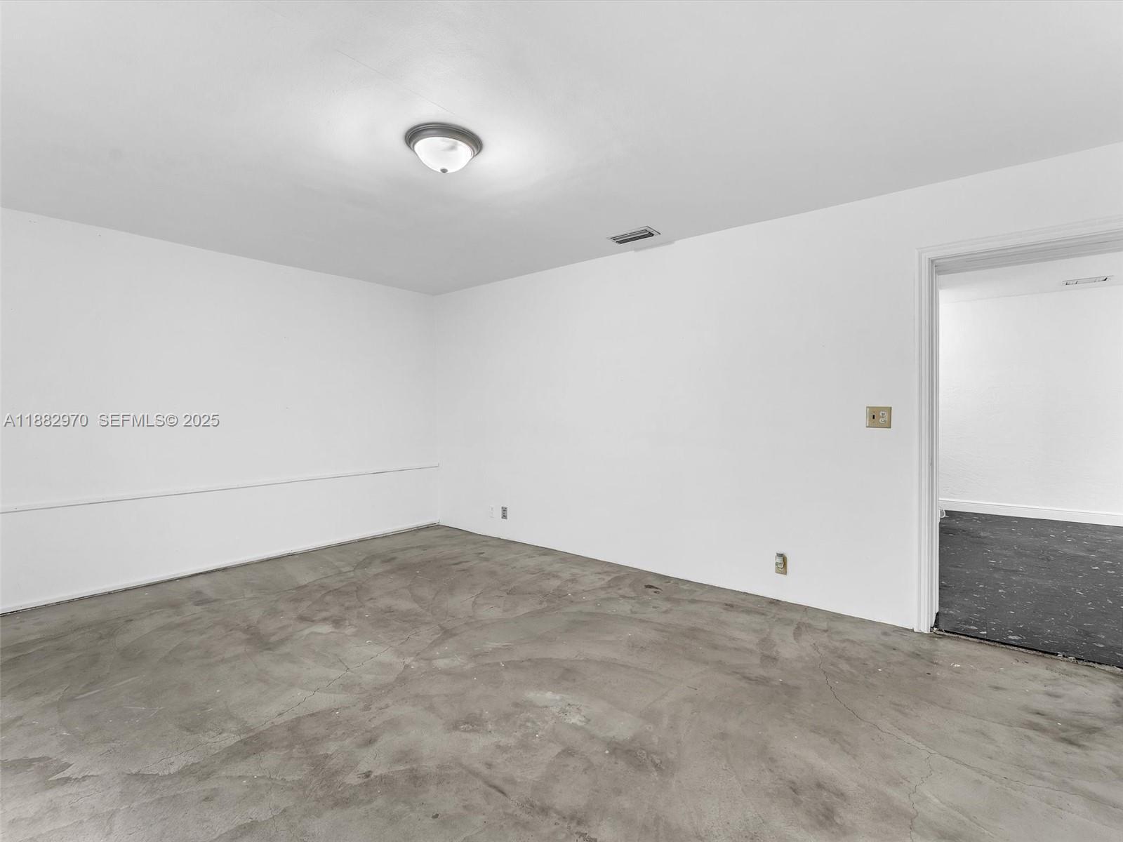 3680 Northwest 16th Street Miami, FL 33125 - Photo 19 of 45 an empty room with an entryway