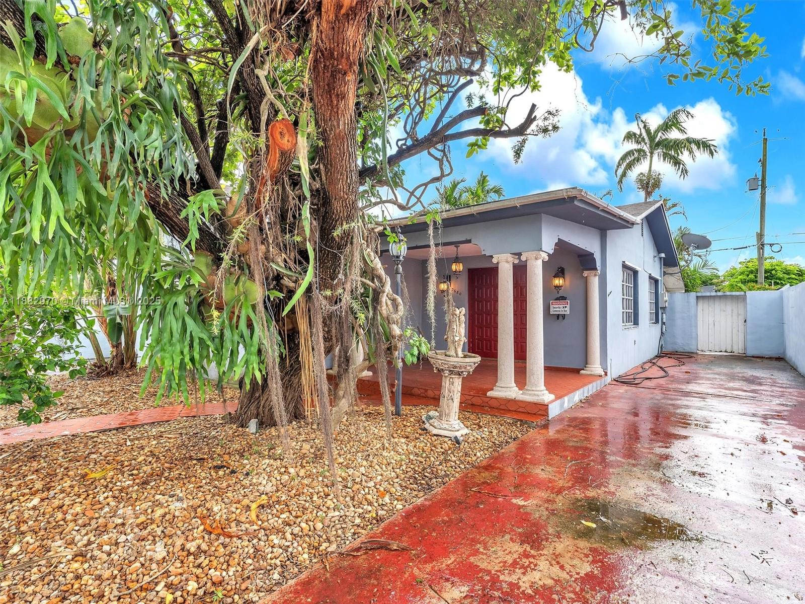 3680 Northwest 16th Street Miami, FL 33125 - Photo 2 of 45 a view of a house with a yard