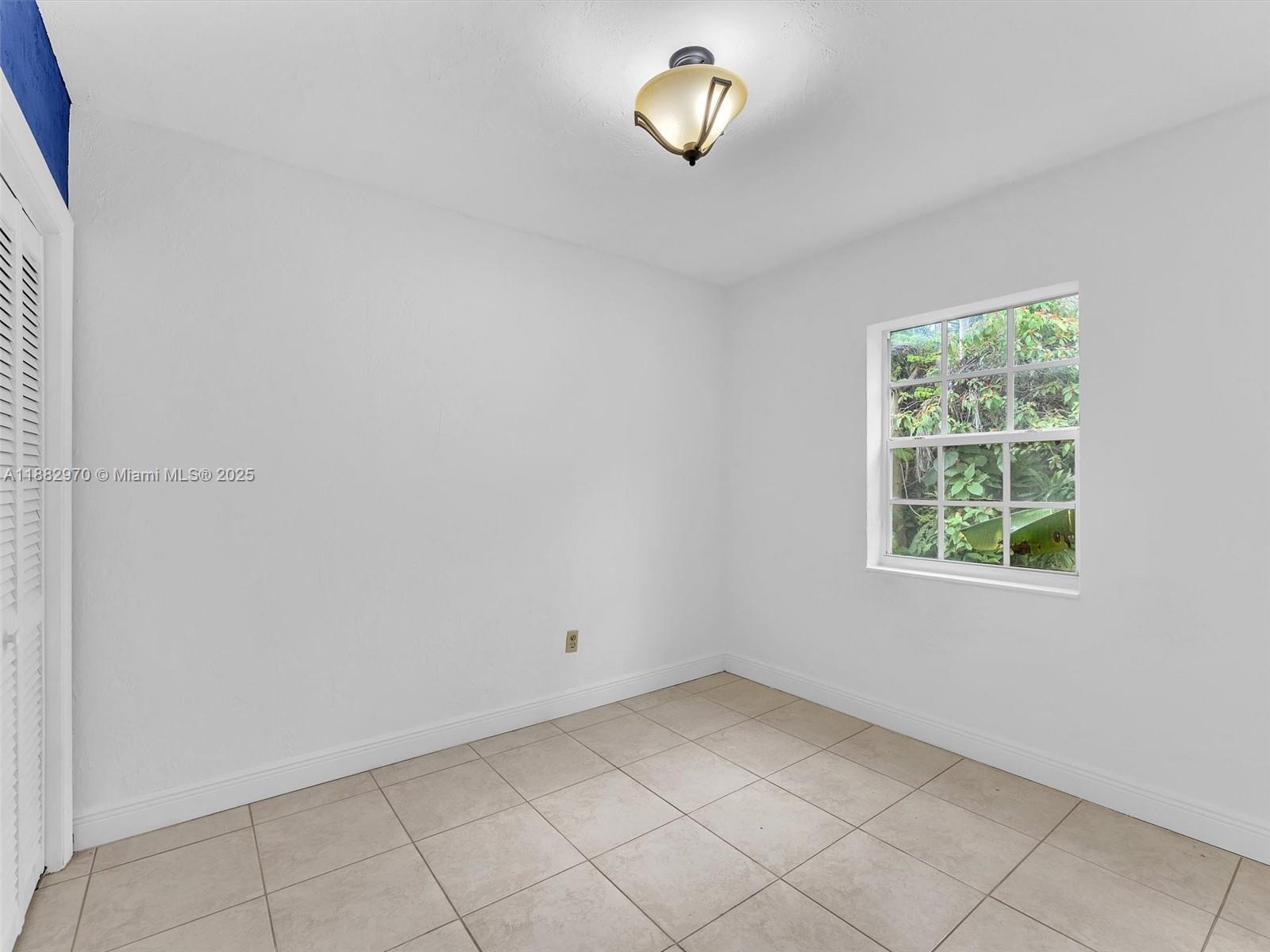 3680 Northwest 16th Street Miami, FL 33125 - Photo 21 of 45 an empty room with a window