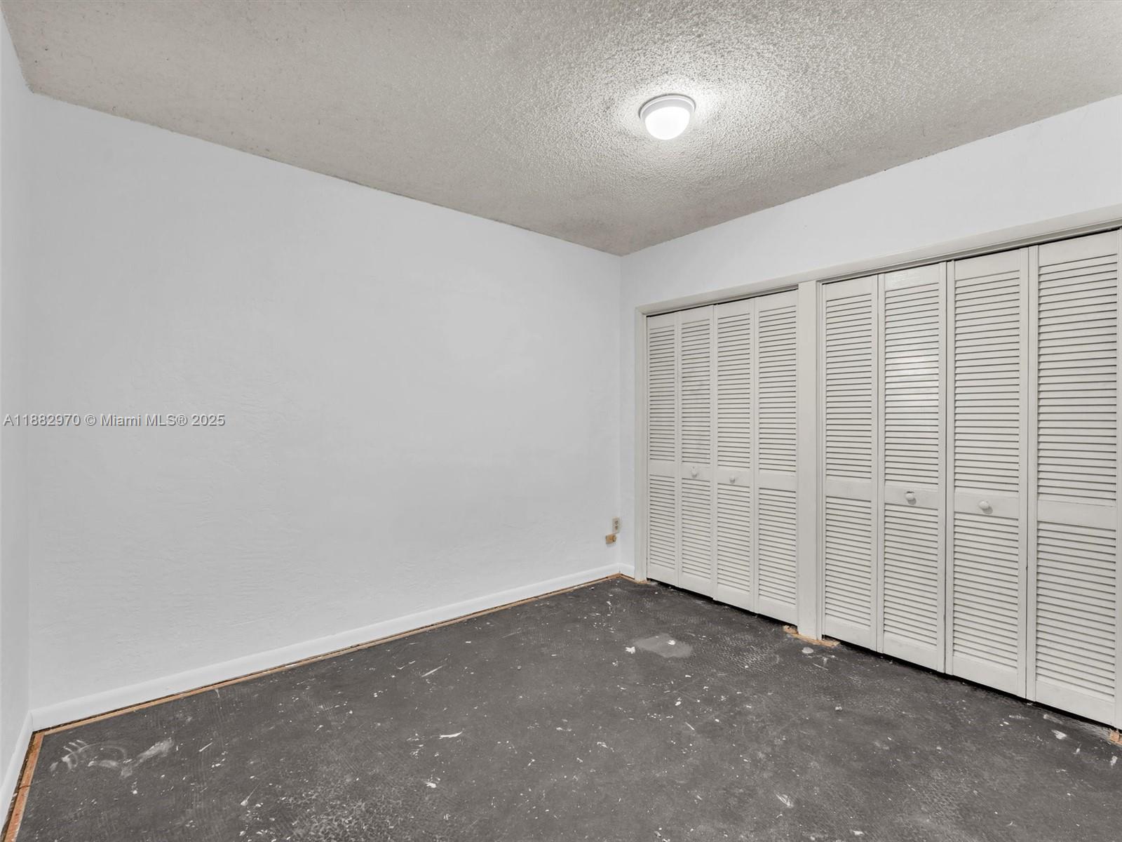 3680 Northwest 16th Street Miami, FL 33125 - Photo 23 of 45 an empty room with sliding door