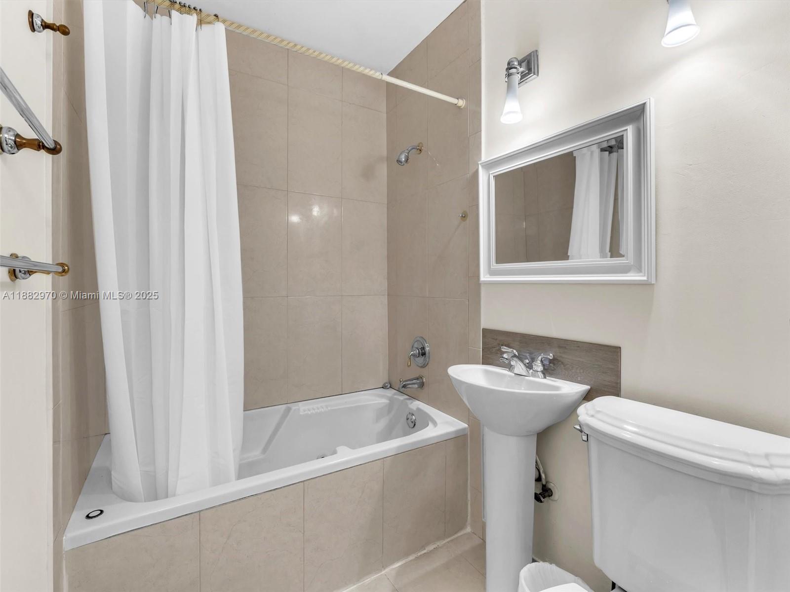 3680 Northwest 16th Street Miami, FL 33125 - Photo 25 of 45 a bathroom with a sink a toilet and shower