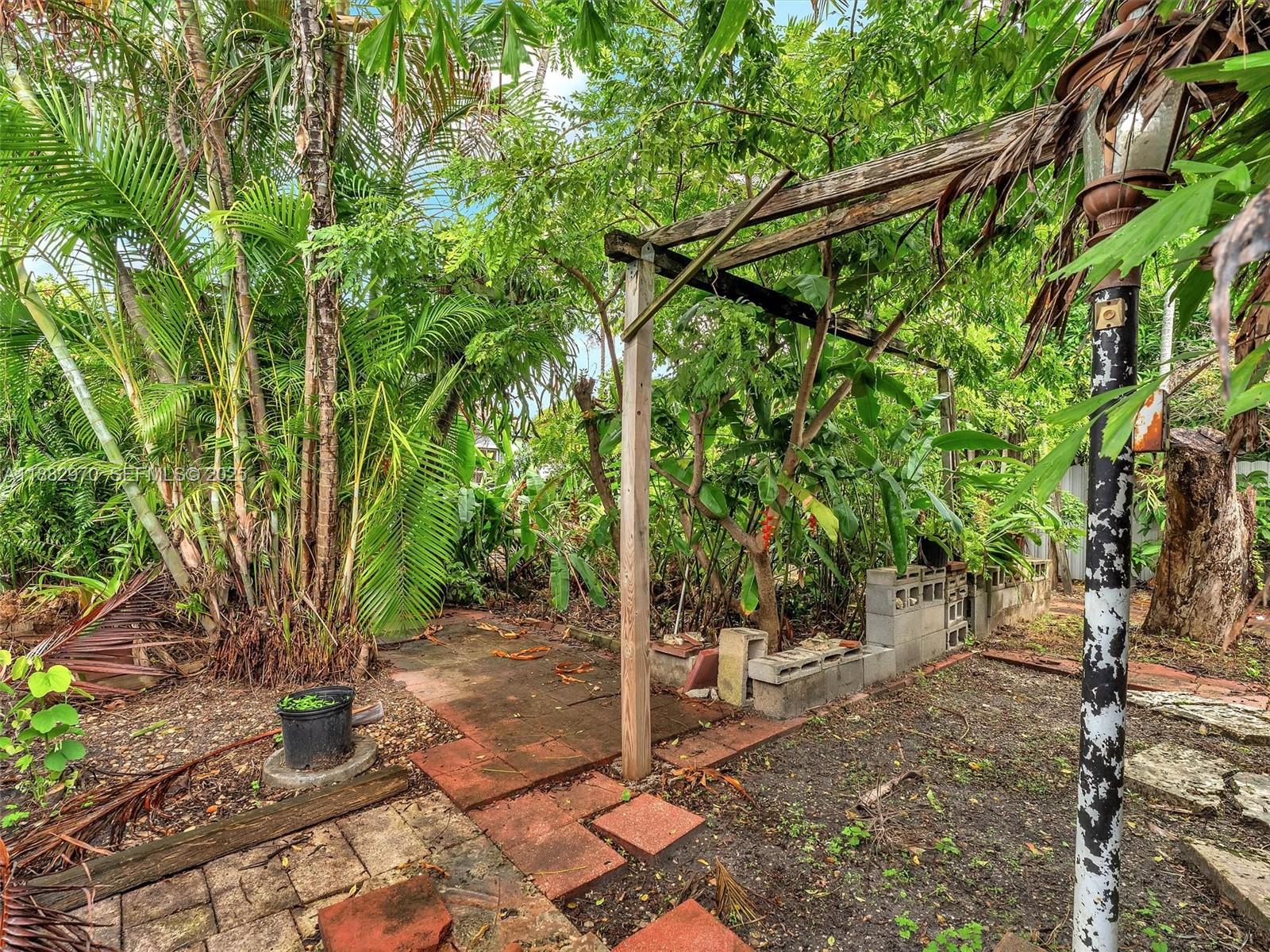 3680 Northwest 16th Street Miami, FL 33125 - Photo 31 of 45 a backyard of a house with lots of green space