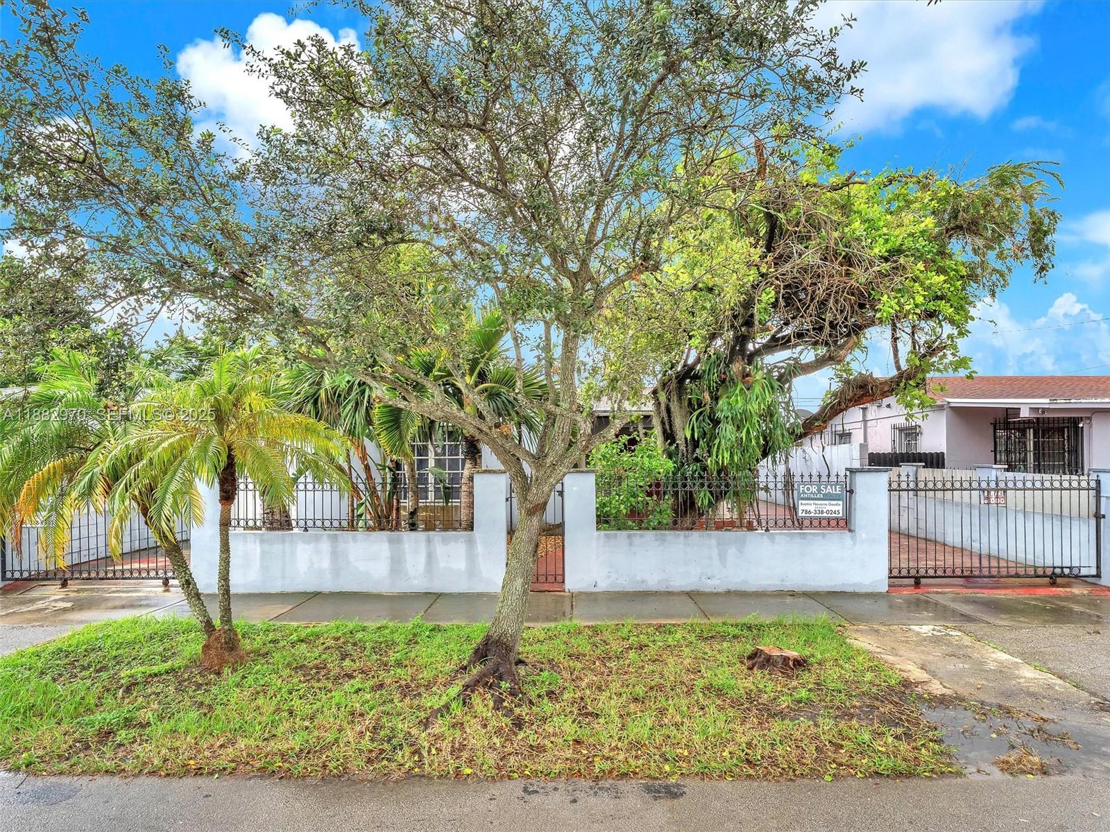 3680 Northwest 16th Street Miami, FL 33125 - Photo 4 of 45 a front view of a house with a garden