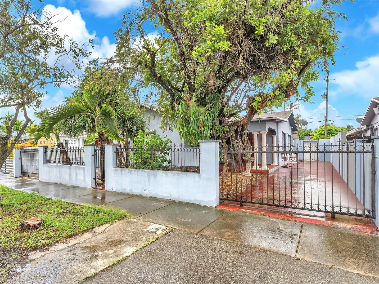 3680 Northwest 16th Street Miami, FL 33125 - Photo 5 of 45 a view of a entrance gate of a house
