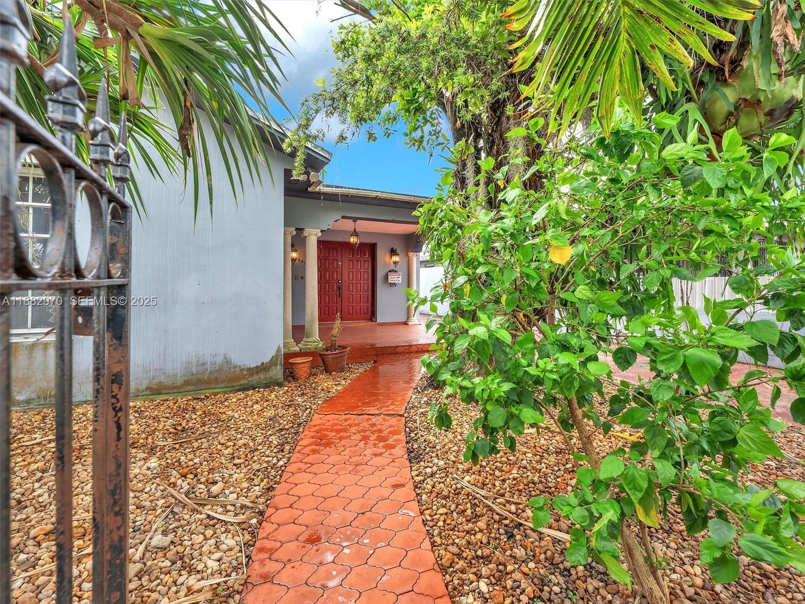 3680 Northwest 16th Street Miami, FL 33125 - Photo 6 of 45 a house with a tree in front of it