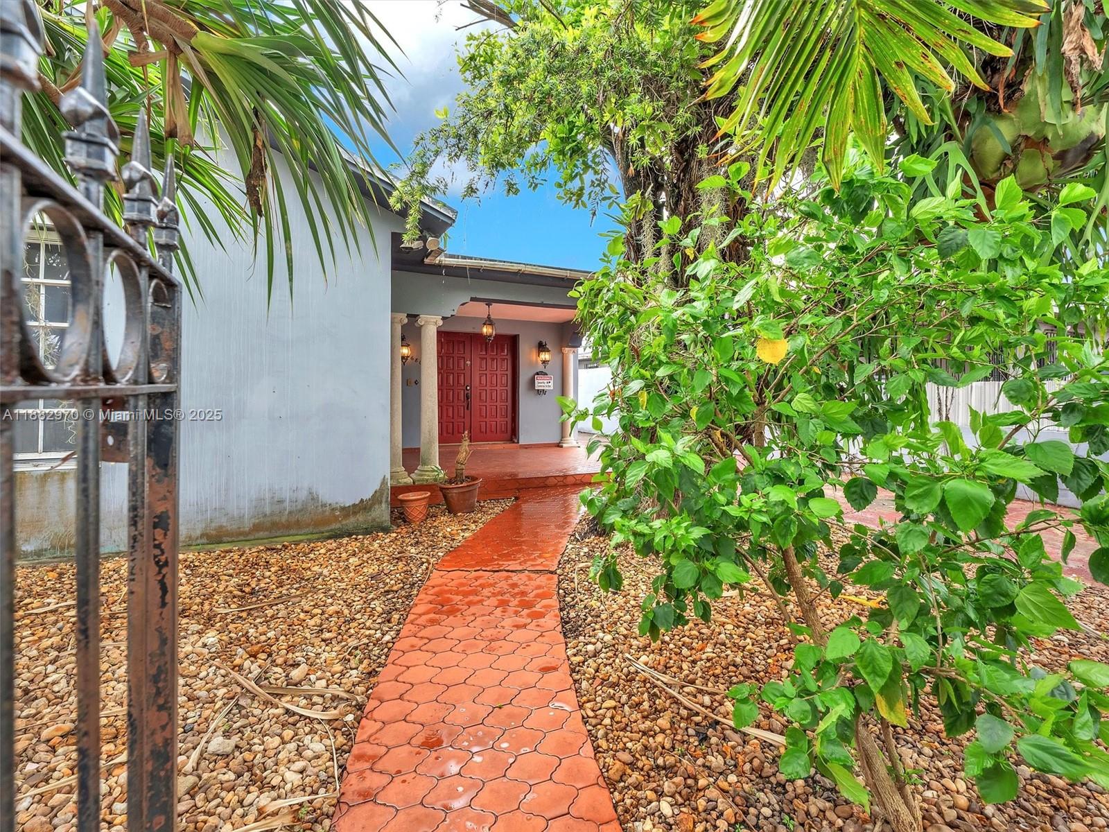 3680 Northwest 16th Street Miami, FL 33125 - Photo 6 of 45 a house with a tree in front of it
