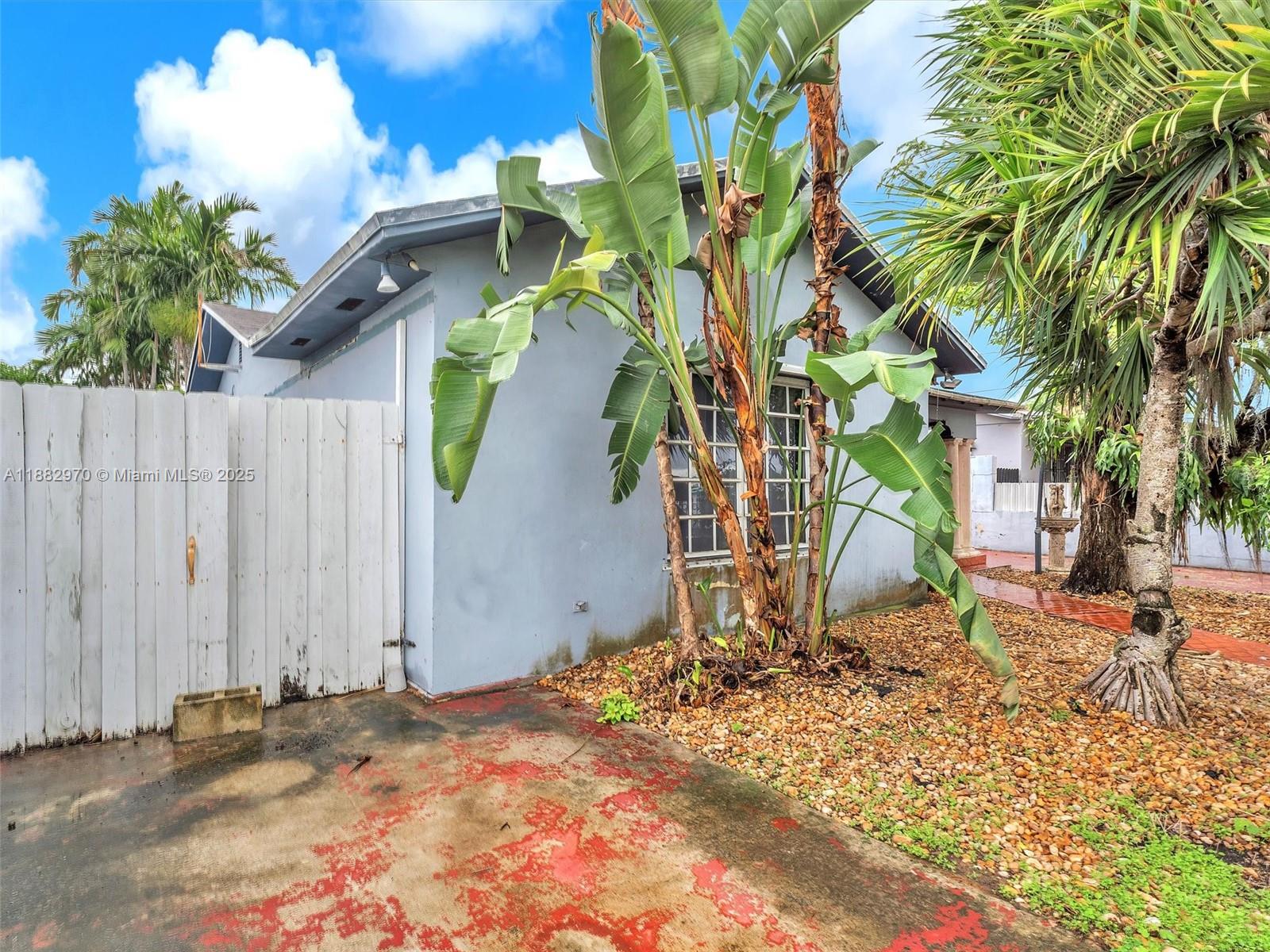 3680 Northwest 16th Street Miami, FL 33125 - Photo 8 of 45 a backyard of a house with table and chairs