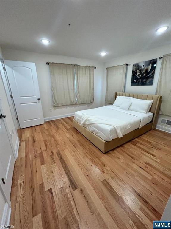 337 13th Avenue Newark, NJ 07103 - Photo 11 of 14 a spacious bedroom with a bed and a dresser