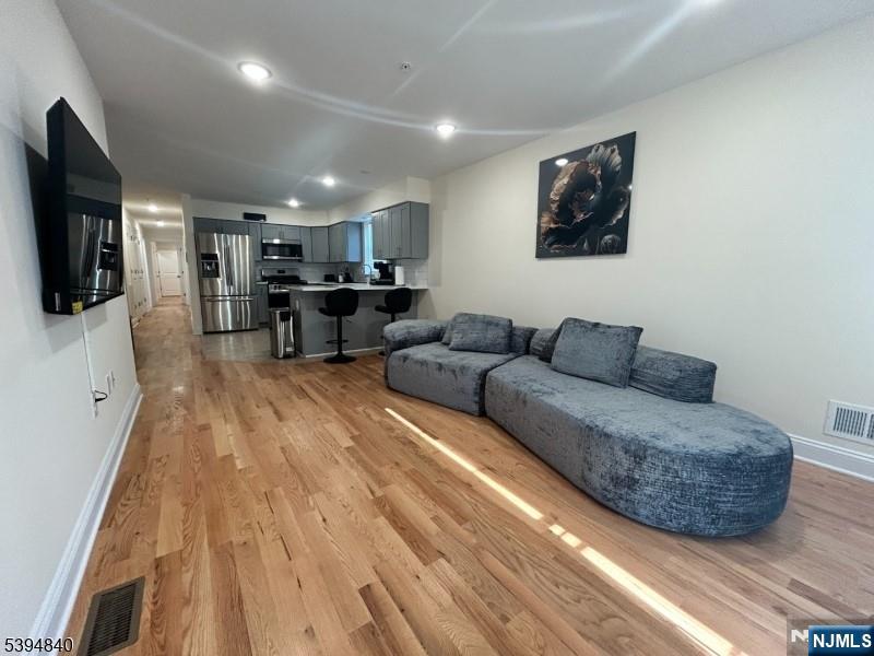 337 13th Avenue Newark, NJ 07103 - Photo 2 of 14 a living room with furniture and a flat screen tv