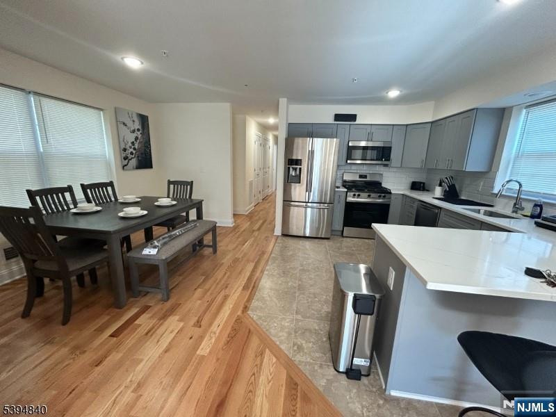 337 13th Avenue Newark, NJ 07103 - Photo 3 of 14 a kitchen with refrigerator and chairs