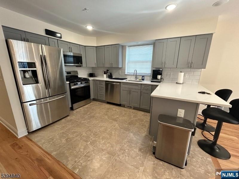 337 13th Avenue Newark, NJ 07103 - Photo 4 of 14 a kitchen with stainless steel appliances granite countertop a refrigerator sink and stove