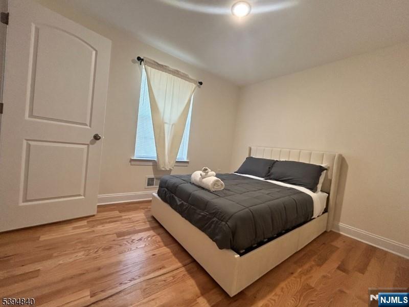 337 13th Avenue Newark, NJ 07103 - Photo 5 of 14 a bedroom with a bed and a window