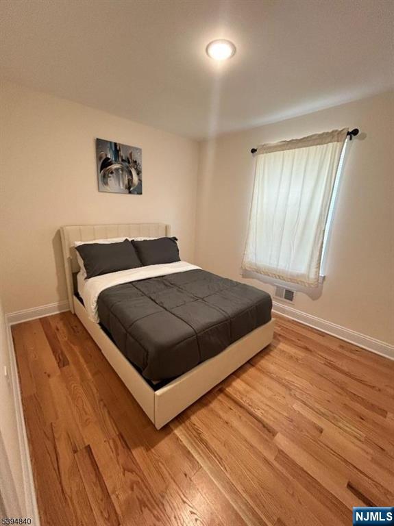 337 13th Avenue Newark, NJ 07103 - Photo 7 of 14 a bedroom with a bed and painting on the wall