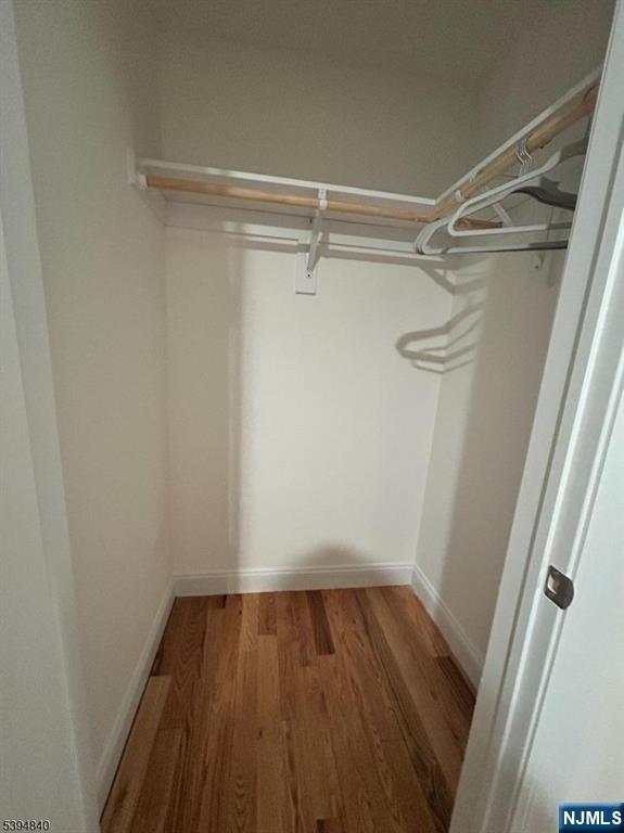 337 13th Avenue Newark, NJ 07103 - Photo 8 of 14 a view of a room with wooden floor and small racks