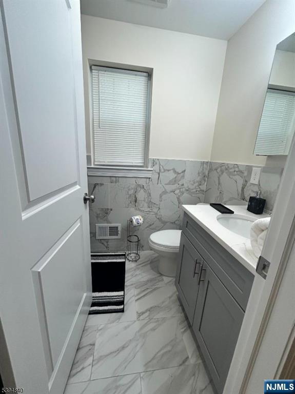 337 13th Avenue Newark, NJ 07103 - Photo 9 of 14 a bathroom with a sink a toilet and mirror