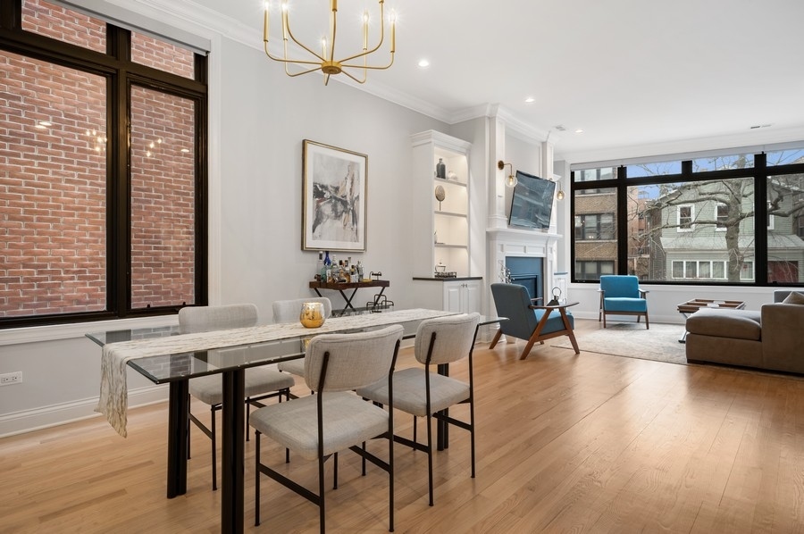 2919 North Burling Street, Unit D Chicago, IL 60657 - Photo 5 of 14 a view of a a dining room with furniture window and wooden floor