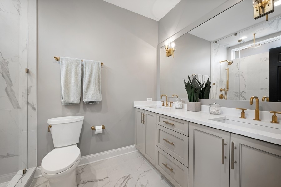 2919 North Burling Street, Unit D Chicago, IL 60657 - Photo 7 of 14 a bathroom with a toilet sink and mirror