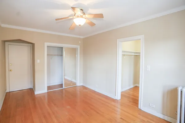 a view of empty room with wooden floor