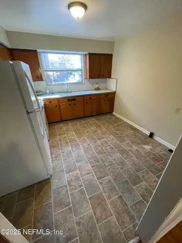 a bathroom with a sink a toilet a mirror and shower