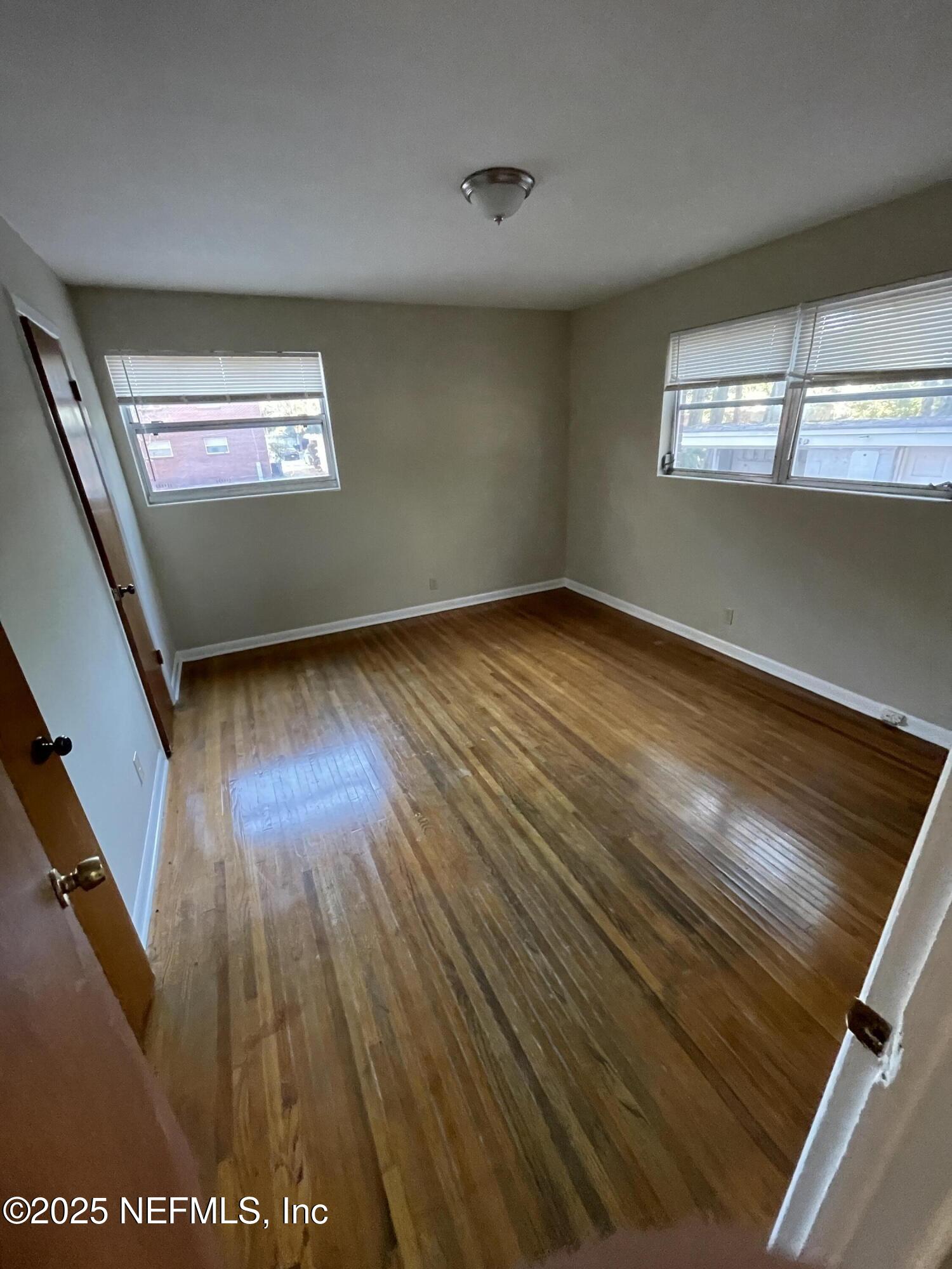5452 Santa Rosa Way, Unit 4 Jacksonville, FL 32211 - Photo 6 of 6 a view of wooden floor and windows in a room