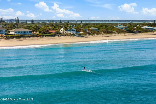 a view of a dining room with furniture a chandelier and wooden floor