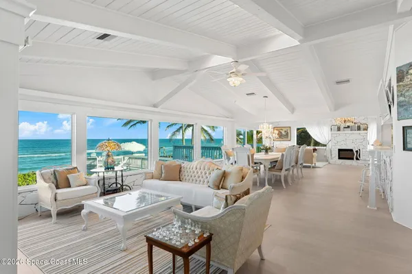 a view of a dining room with furniture a chandelier and wooden floor