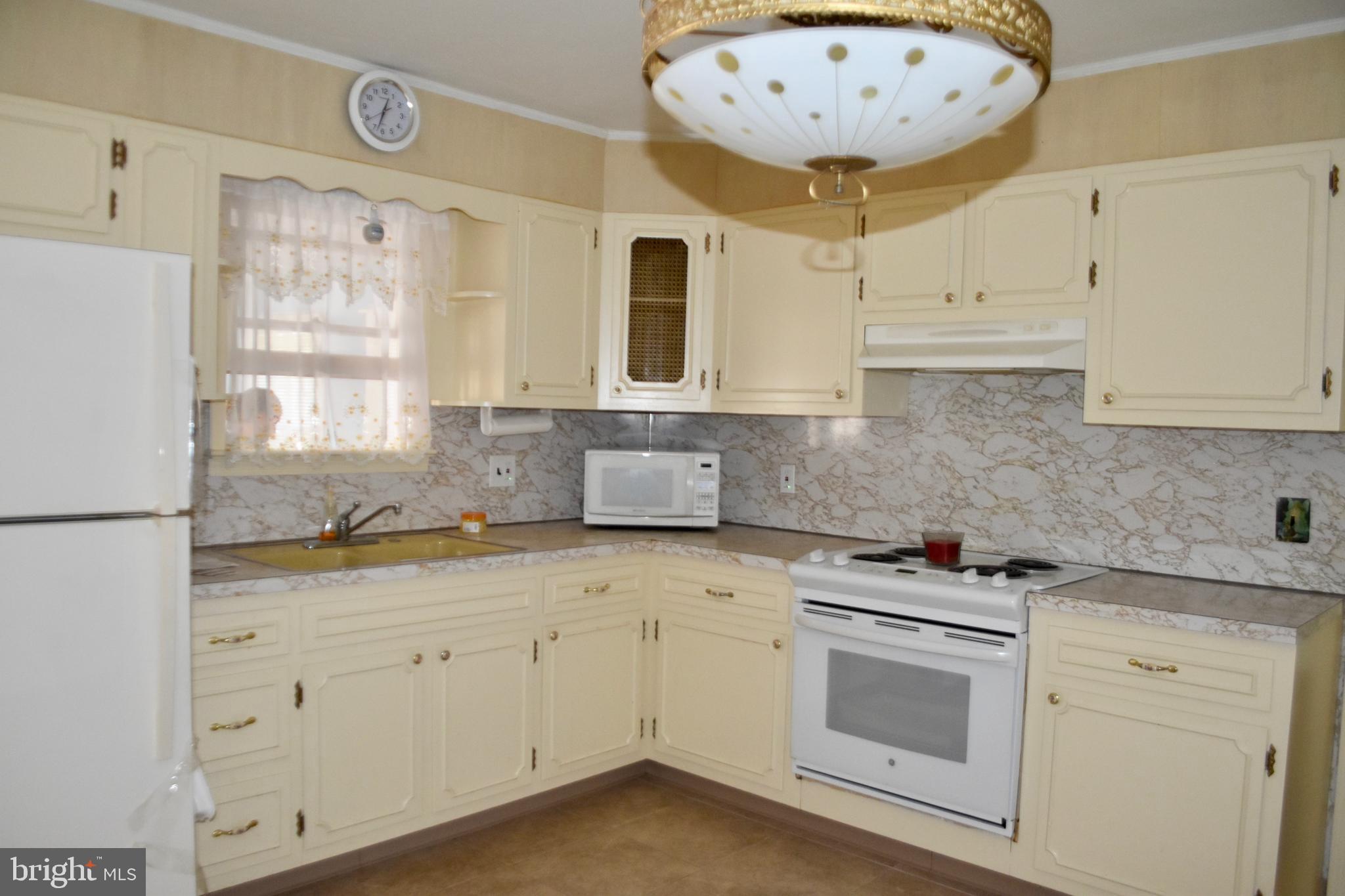 509 Walker Avenue Ewing, NJ 08628 - Photo 4 of 20 a kitchen with granite countertop white cabinets and white appliances
