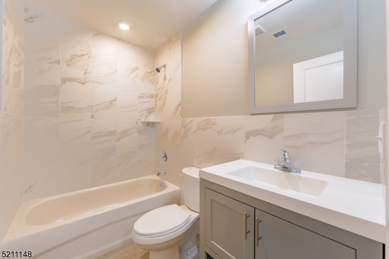 255 Chadwick Avenue, Unit 2 Newark, NJ 07108 - Photo 11 of 23 a bathroom with a sink a toilet and shower